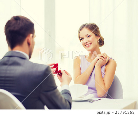 excited young woman looking at boyfriend with ring excited young woman looking at boyfriend with ring 25791565
