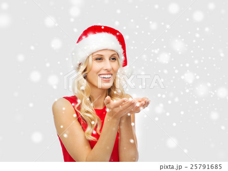 happy woman in santa hat holding something on palm 25791685
