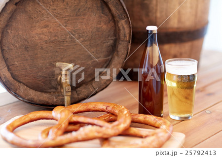 close up of beer barrel, glass, pretzel and bottle 25792413