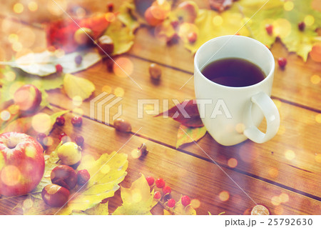 close up of tea cup on table with autumn leaves close up of tea cup on table with autumn leaves 25792630