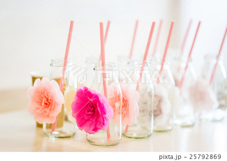 close up of glass bottles for drinks with straws 25792869