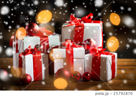 gift boxes and red christmas balls on wooden floor gift boxes and red christmas balls on wooden floor 25792870