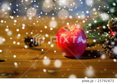 close up of apple with fir decoration on wood 25792873