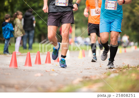 Group of unrecognizable runners outdoors. Long Group of unrecognizable runners outdoors. Long 25808251