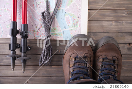 Equipment for hiking on a wooden floor background. 25809140