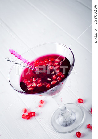 Pomegranate martini with seeds in a glass Pomegranate martini with seeds in a glass 25809296