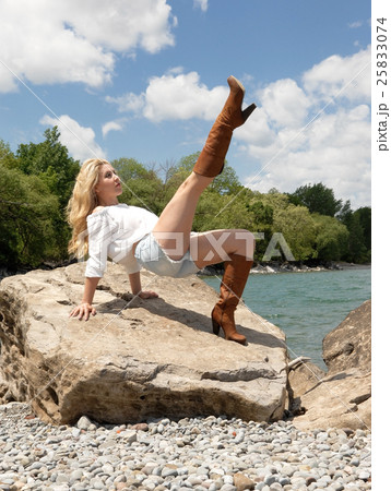 Young woman exercising on lake. Young woman exercising on lake. 25833074