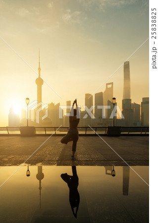 Silhouette of Asian woman make yoga in Shanghai Silhouette of Asian woman make yoga in Shanghai 25838825