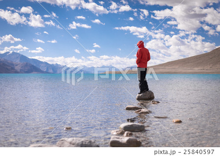 Traveler standing on the rock at Pangong Lake 25840597