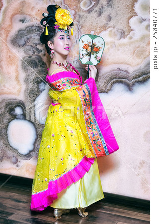 chinese woman wearing traditional yellow dress 25840771