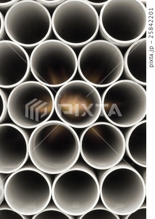 PVC pipes stacked in warehouse. 25842201