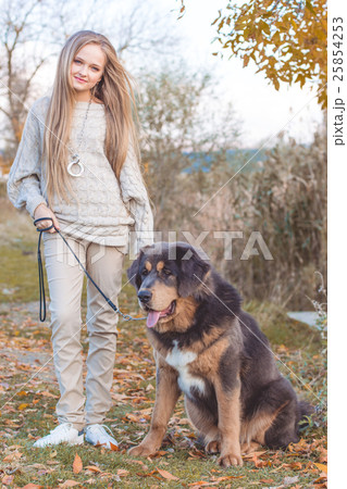 Pretty blonde girl with mastiff on the nature 25854253
