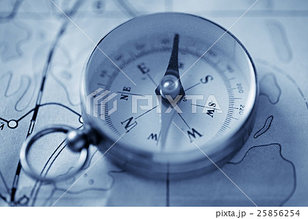 Close-up of a magnetic compass and a map 25856254