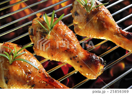 Grilled chicken legs on the flaming grill Grilled chicken legs on the flaming grill 25856369