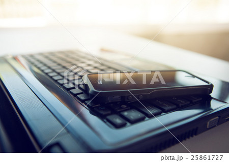 Closeup picture of a keyboard with a phone  25861727
