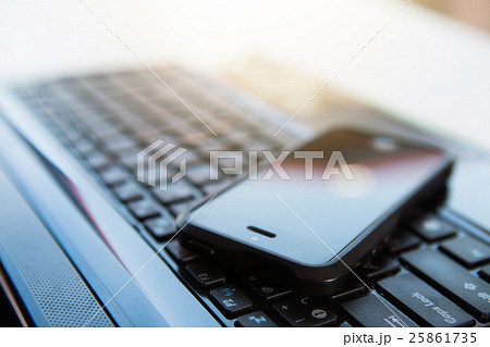 Closeup picture of a keyboard with a phone 25861735