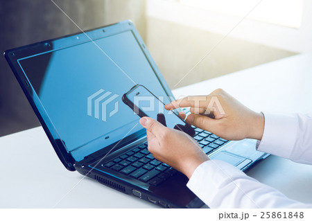 man working at office using smart phone  man working at office using smart phone  25861848