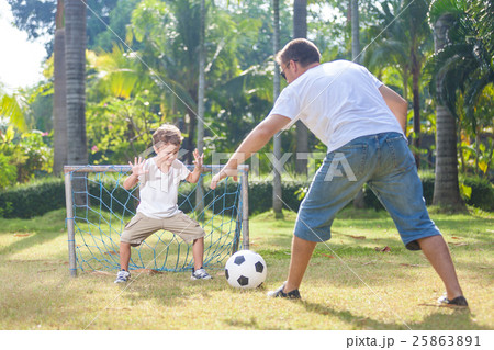Father and son playing in the park  at the day time. 25863891