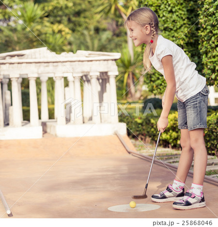 Little girl swinging golf club 25868046