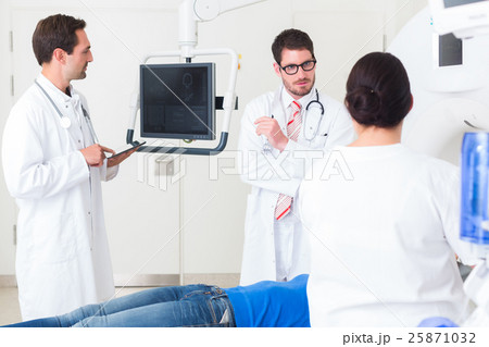 Doctors in hospital at CT scan with patient Doctors in hospital at CT scan with patient 25871032