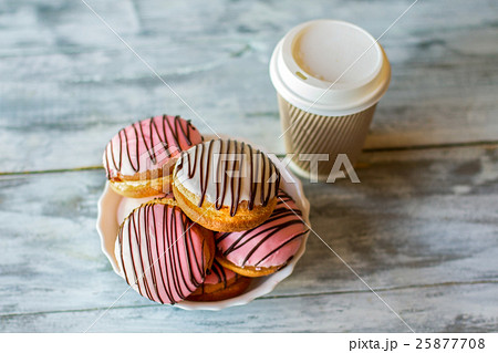 Glazed cookies near a cup. 25877708
