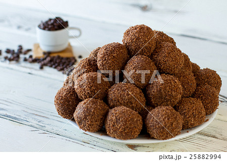 Brown candies on white plate. Brown candies on white plate. 25882994