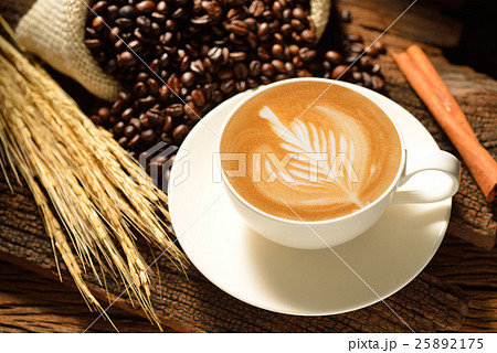 Cafe latte and coffee beans on wooden background 25892175