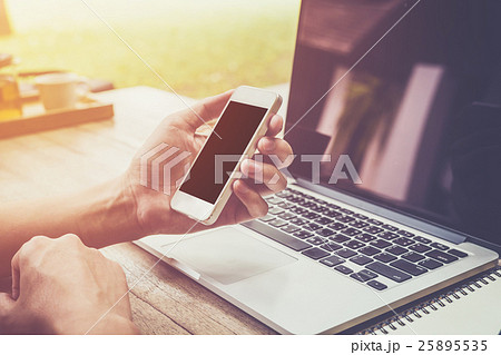 young business man hand holding phone 25895535