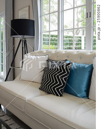 white and blue pillows on a couch in living room 25900862