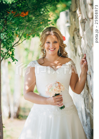 Stylish beautiful happy bride holding  bouquet  25908973