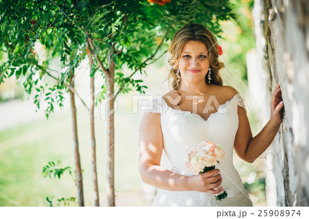 Stylish beautiful happy bride holding  bouquet  25908974