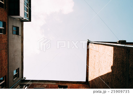 View from below on old brick house with blue sky 25909735