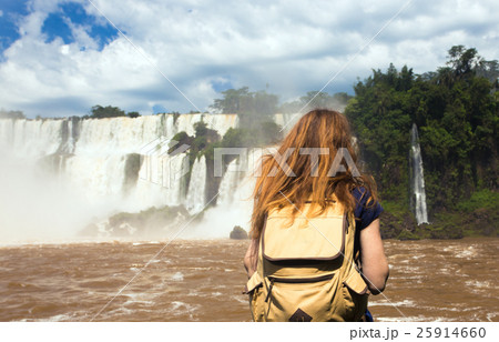 girl tourist looking at the Iguassu falls girl tourist looking at the Iguassu falls 25914660