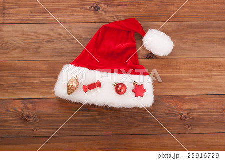 Santa hat Claus with toys on wooden background. Santa hat Claus with toys on wooden background. 25916729