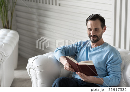 Happy intelligent man reading a book Happy intelligent man reading a book 25917522
