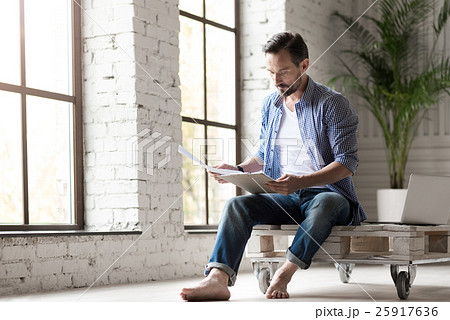 Good looking serous man holding documents Good looking serous man holding documents 25917636
