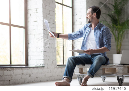 Positive nice man reading a document Positive nice man reading a document 25917640