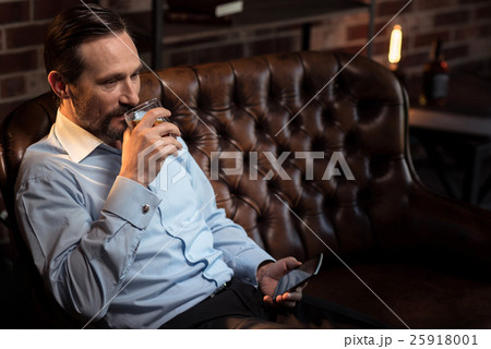 Delighted good looking man drinking alcohol 25918001