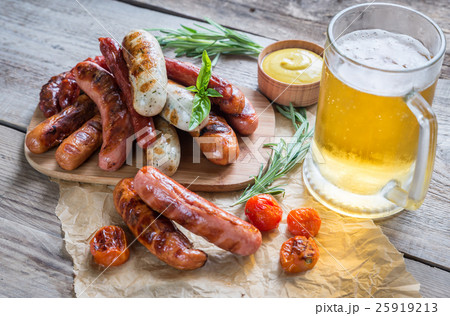 Grilled sausages with glass of beer 25919213