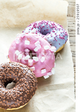Colourful donuts on the baking paper 25919507
