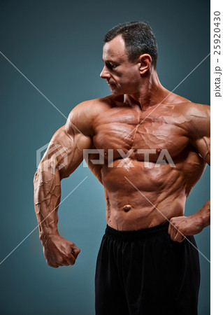 torso of attractive male body builder on gray torso of attractive male body builder on gray 25920430