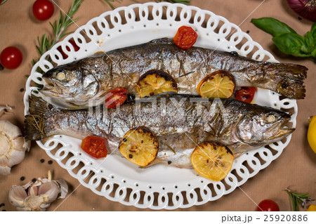 delicious trout fish baked with lemon, tomatoes 25920886