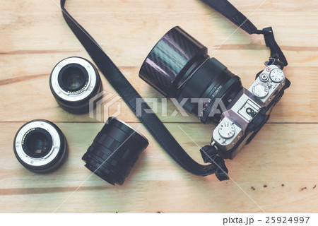 Camera with accessory on table. Vintage processed 25924997