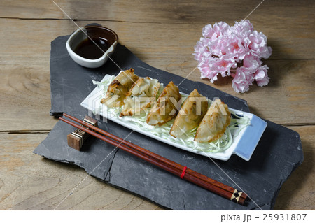 fried dumplings or gyoza on wood background 25931807