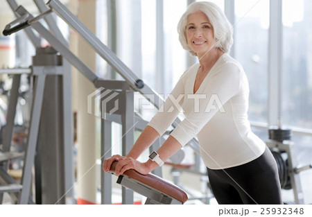 Cheerful fit senior woman using gym equipment. Cheerful fit senior woman using gym equipment. 25932348