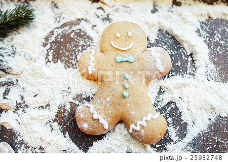 Gingerbread man making snow angel on flour 25932748