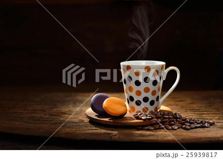 Cup of coffee with coffee beans and pastries Cup of coffee with coffee beans and pastries 25939817