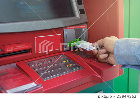 Closeup of male hands using and with insert ATM card into bank machine for withdraw the money, business technology banking concept Closeup of male hands using and with insert ATM card into bank machine for withdraw the money, business technology banking concept 25944562