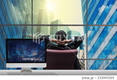 Back side of sitting businessman who is looking at citiy out off windows glass with Computer set show Trading graph on the cityscape and world map background on the table, Business financial concept 25944564