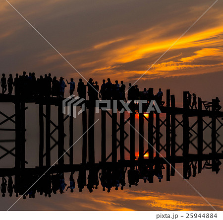 Sunset with silhouettes of many people on the U-Bein Bridge is the longest. in Amarapura ,Mandalay ,Myanmar 25944884